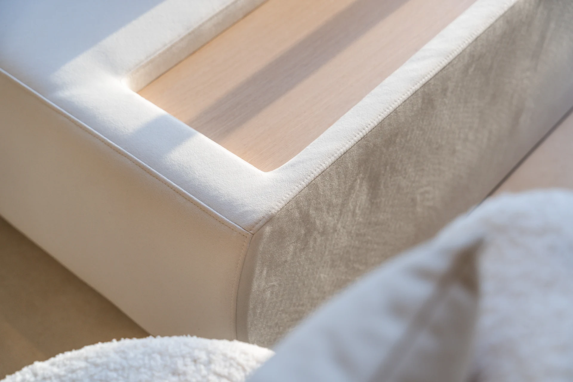 Maple Villa — Custom-made upholstery is resolved with an inset timber detail, tailored precisely to the furniture’s form.