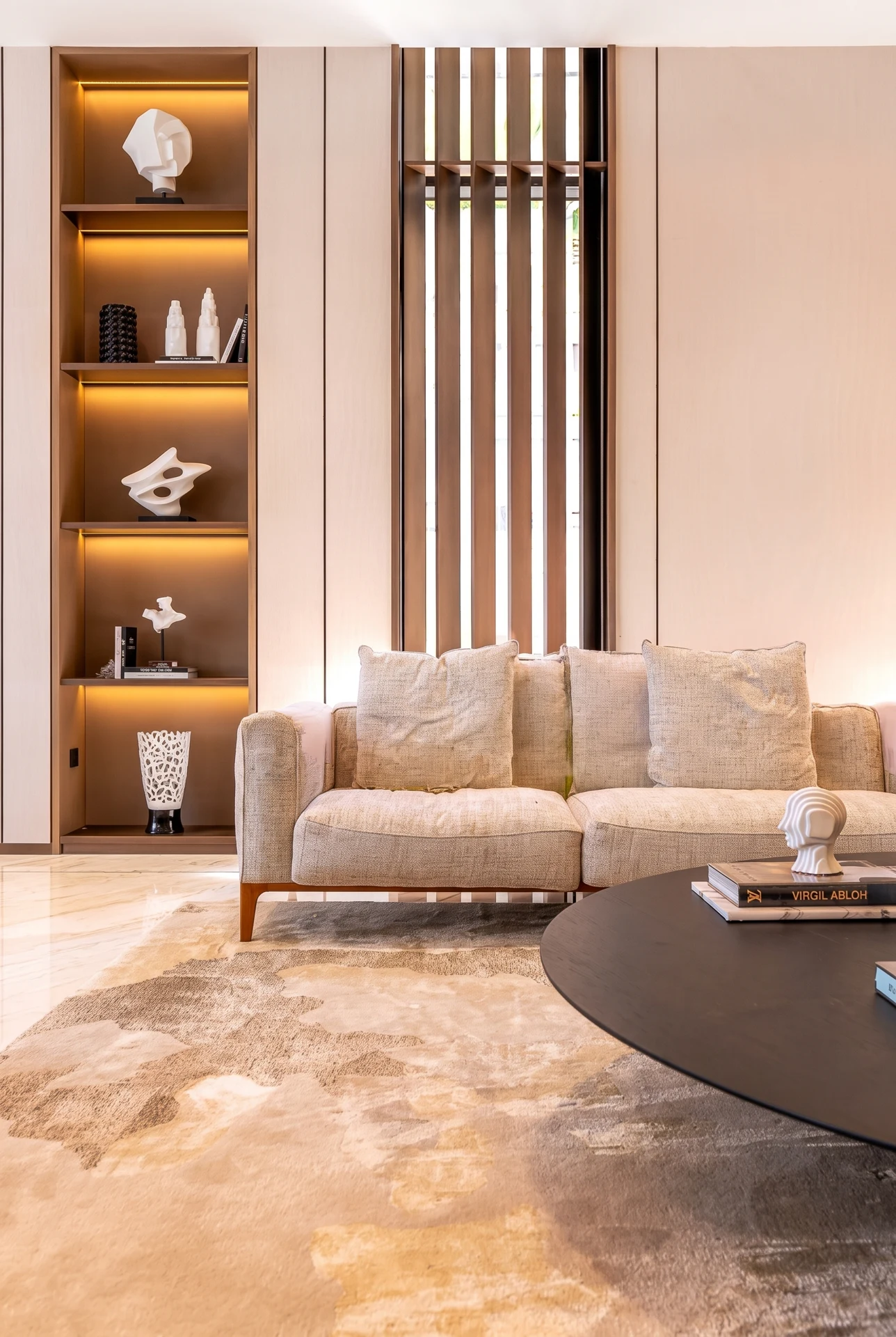 Jumeirah Bay Island Mansion — Illuminated display joinery and a slender timber screen give warmth and rhythm to the room.