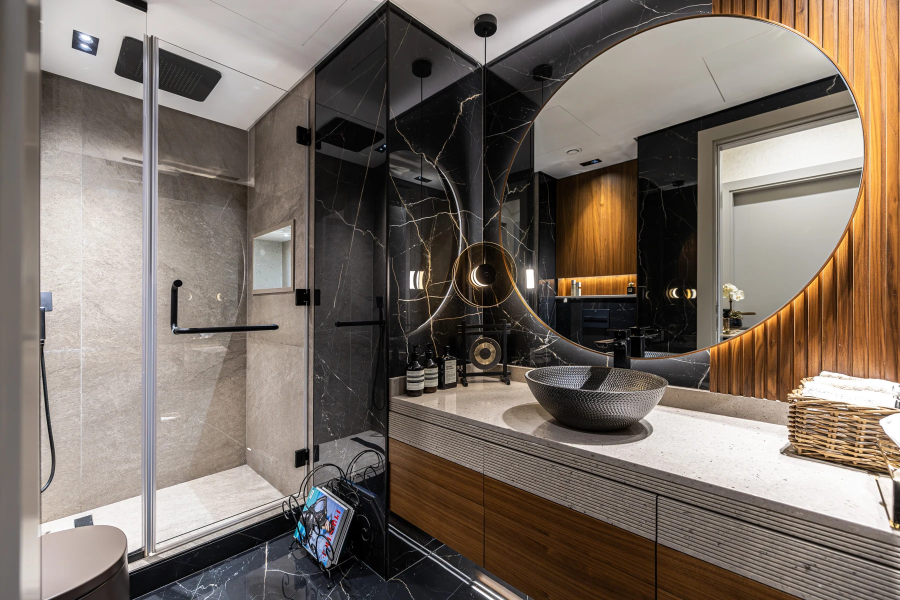 Sidra 1 Villa — Veined stone, a curved mirror and integrated lighting form one continuous composition.