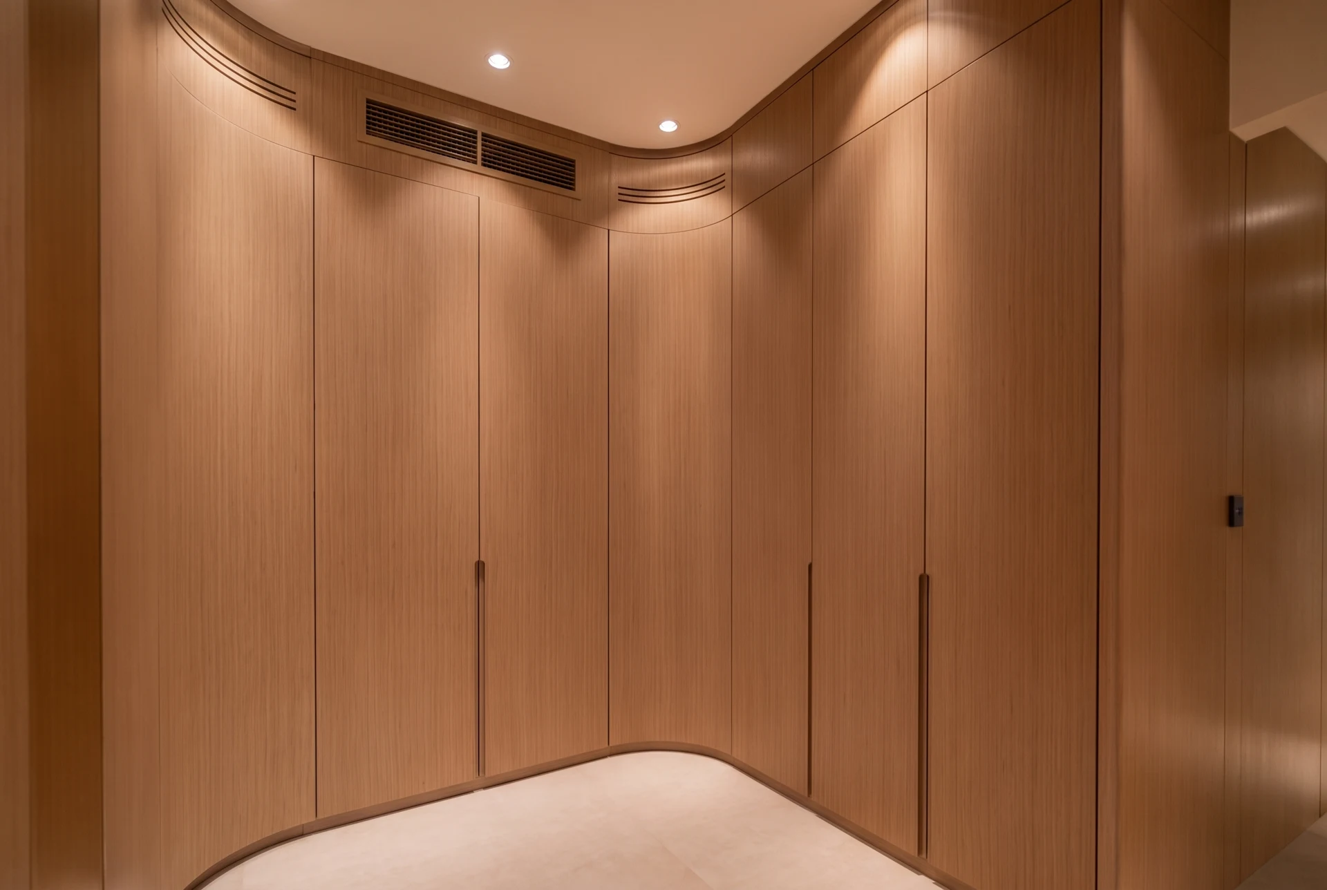 Maple Villa — A softly curved wardrobe composition shapes the walk-in closet as one continuous interior.