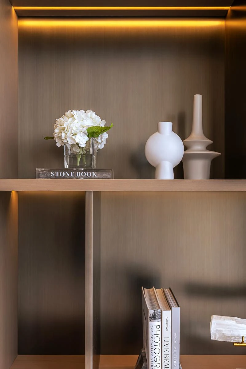 Jumeirah Bay Island Mansion — Concealed linear lighting provides even illumination across the display shelves.